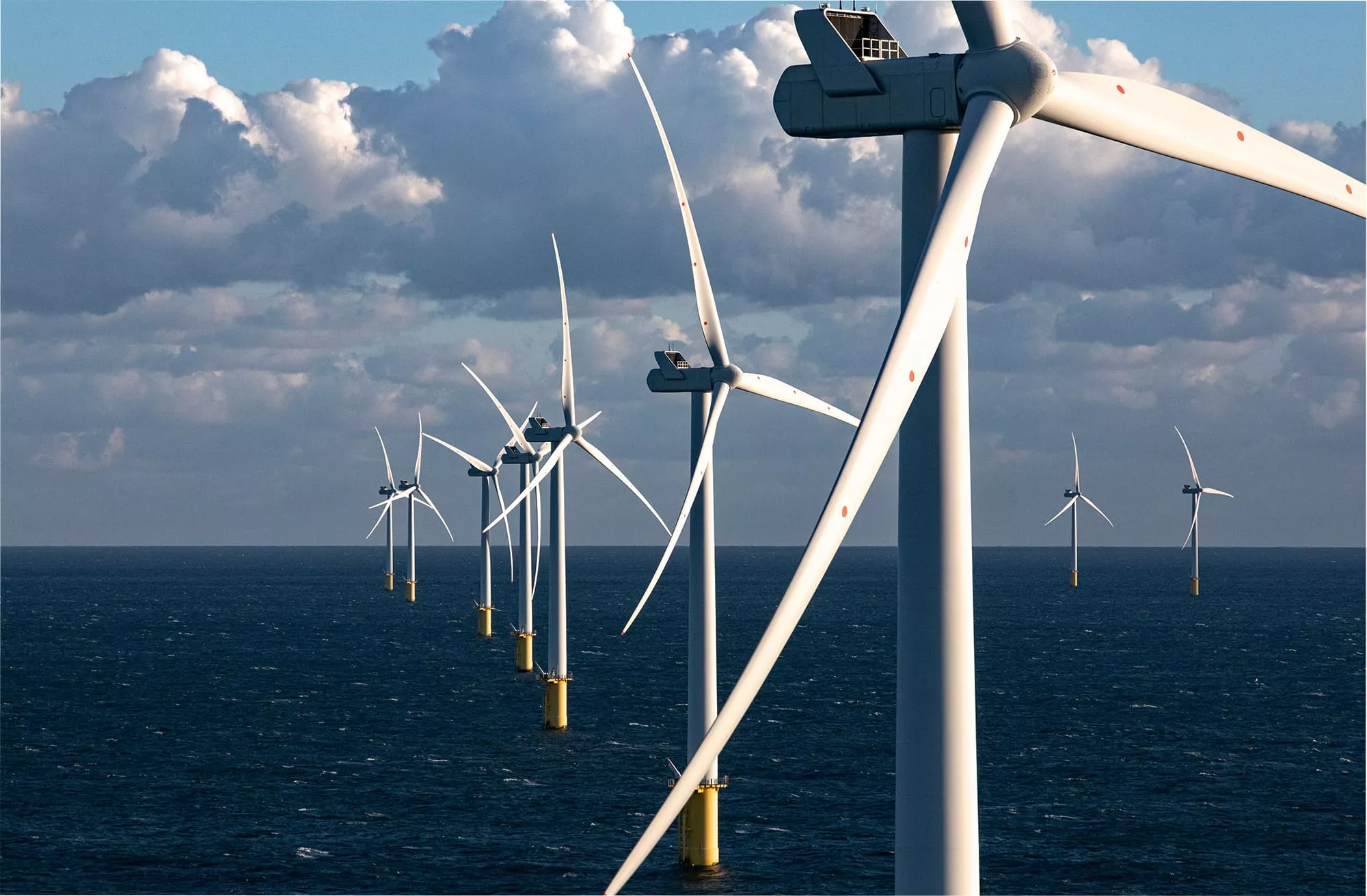 Offshore wind turbines stand tall above the ocean