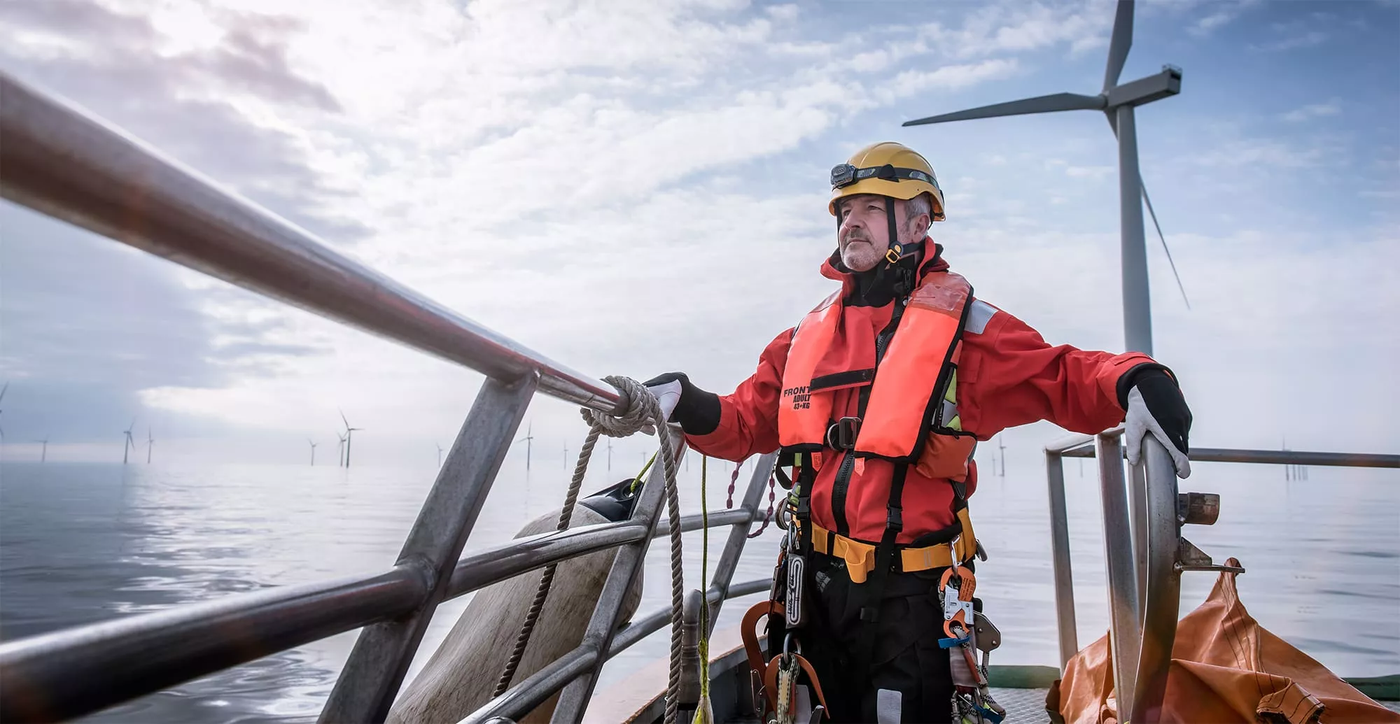 Wind farm technician on boat near offshore turbine 